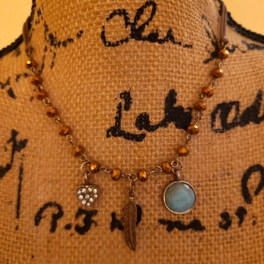 Crystal heart, metal feather, and stone pendant charm necklace costume jewlery.
